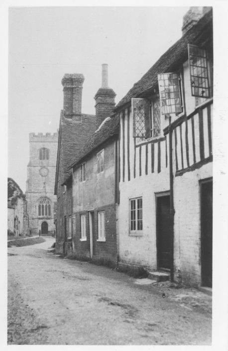 A historical photo of the parish church, street and houses
